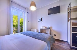 A bed or beds in a room at Albergo Silvio