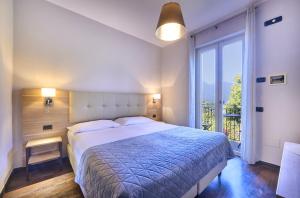 A bed or beds in a room at Albergo Silvio