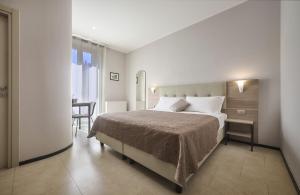 A bed or beds in a room at Albergo Silvio
