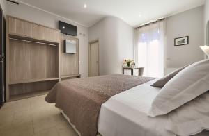 A bed or beds in a room at Albergo Silvio