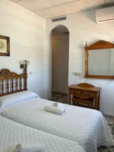 Postel nebo postele na pokoji v ubytování Hostal Quinto Pino