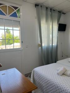 Postel nebo postele na pokoji v ubytování Hostal Quinto Pino
