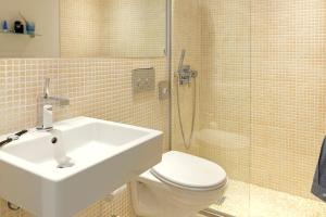 a bathroom with a sink and a toilet and a shower at Scandic Front in Copenhagen