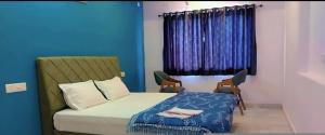 a bedroom with a bed and a blue wall at The prem bag hotel debari Udaipur in Debāri