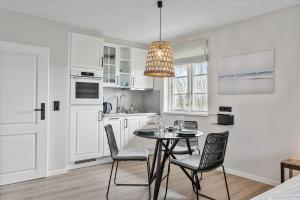 a kitchen with a table and chairs in a room at Beach Lodge Beach Lodge Appartement 2 in Böhl +12 photos