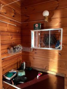 a room with a wooden wall with a window at Mönni saari in Savonlinna +41 photos