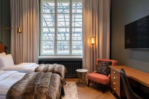 Ένα ή περισσότερα κρεβάτια σε δωμάτιο στο Scandic Grand Central Helsinki