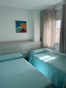 Postel nebo postele na pokoji v ubytování Apartamentos La Proa