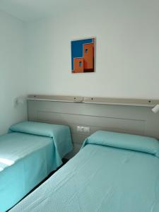 Postel nebo postele na pokoji v ubytování Apartamentos La Proa