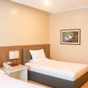 Iloilo Gateway Hotel and Suites客房内的一张或多张床位