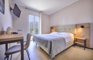 A bed or beds in a room at Albergo Silvio