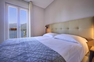 A bed or beds in a room at Albergo Silvio