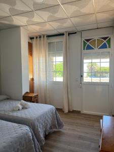 Postel nebo postele na pokoji v ubytování Hostal Quinto Pino