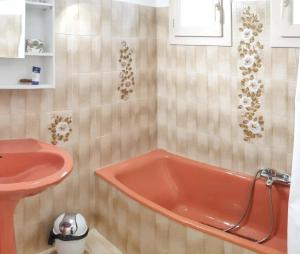a bathroom with a red tub next to a sink at Maison accueillante à Saint-Laurent-du-Var avec jardin in Saint-Laurent-du-Var +20 photos