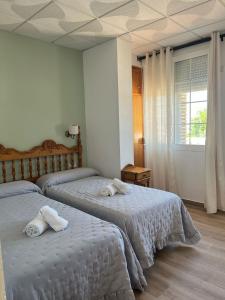 Postel nebo postele na pokoji v ubytování Hostal Quinto Pino