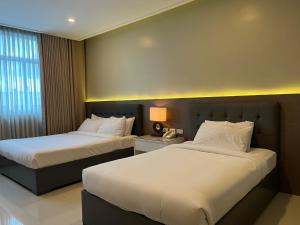 Iloilo Gateway Hotel and Suites客房内的一张或多张床位