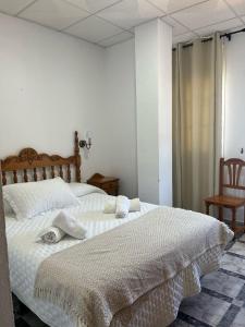 Postel nebo postele na pokoji v ubytování Hostal Quinto Pino