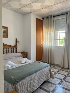Postel nebo postele na pokoji v ubytování Hostal Quinto Pino