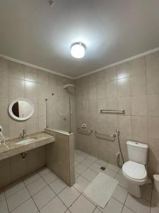 a bathroom with a toilet and a sink and a mirror at Hotel Charme Fonte do Boi in Salvador +51 photos