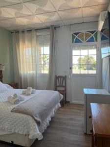 Postel nebo postele na pokoji v ubytování Hostal Quinto Pino