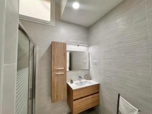 a bathroom with a sink and a mirror at Casa Fe in Morro del Jable
