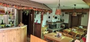 a restaurant with tables and chairs and a fireplace at Hotel - Pension Wendland in Wintrich