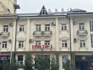 a hotel building with a hotel sign on it at VOSTOK in Samarkand
