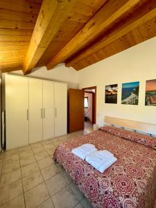 a bedroom with a bed with two towels on it at Agriturismo Conero in Ancona