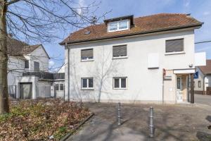 a white house with a tree in front of it at Amalfi A11 - 4 Betten - 2 Zimmer - mit großer Terrasse in Dreieich