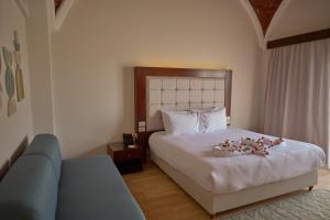 a hotel room with a bed with flowers on it at Diamond Beach by Pearl Resorts in Quseir