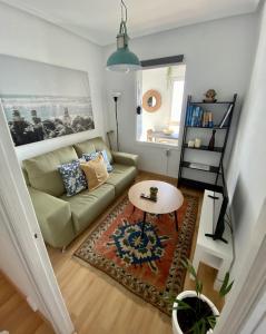 a living room with a couch and a table at Respirando salitre apartamento en Lastres in Lastres