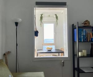 a room with a door with a window and a table at Respirando salitre apartamento en Lastres in Lastres