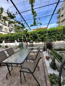 a patio with a glass table and chairs at Peraia Luxury Studio in Perea