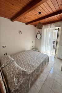 a bedroom with a bed and a wooden ceiling at Casa Vacanze Aurora in Coccorino