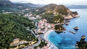 an aerial view of a town on the shore of a body of water at LefkoParga Luxury Suites in Parga