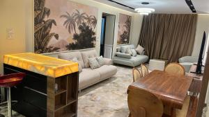 a living room with a couch and a table at Compound Gardaina city in Cairo