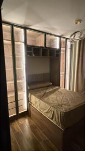 a small bedroom with a bed in a room at Compound Gardaina city in Cairo