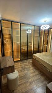 a bedroom with a bed and a table in a room at Compound Gardaina city in Cairo