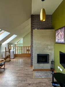 a living room with a fireplace and a brick wall at Atpūta Grašos Upesgrīva in Upesgrīva