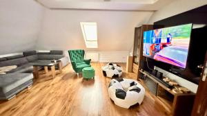 a living room with a couch and a flat screen tv at Na Górce in Kurnatowice