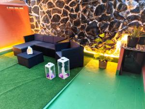 a living room with a couch and a rock wall at Dúplex Casa Nerea in Santa Cruz de la Palma +2 photos