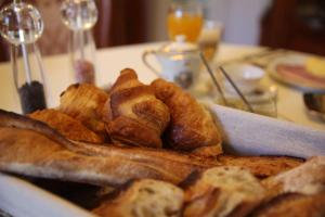 a plate of bread and pastries on a table at Le Clos Morin - Chambres d'hôtes in Giverny