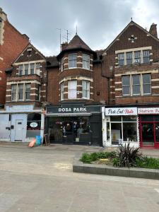 a large brick building with a store in the street at Parkend Room Stays in Oxford