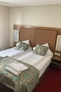 a hotel room with a bed with towels on it at Hotel Villa Erlen in Erlangen