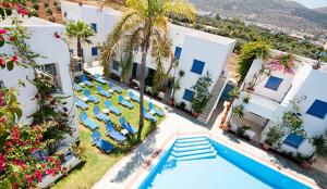 an aerial view of a resort with a swimming pool and chairs at Galini Studios and Apartments in Malia