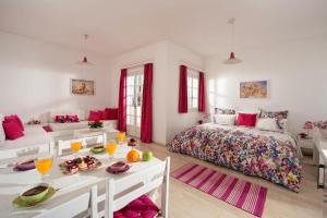 a bedroom with a bed and a table with food on it at Galini Studios and Apartments in Malia
