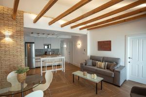a living room with a couch and a table at VELALMA-CERON Edificio exclusivo de apartamentos turisticos en Centro histórico in Jaén