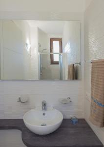 a bathroom with a white sink and a mirror at Nitrodi Thermal Relais in Ischia +15 photos