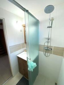 a shower with a glass door in a bathroom at Horská Chata Martin in Loučná pod Klínovcem