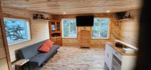 a living room with a blue couch in a cabin at Rustic Treehouse in Peyton